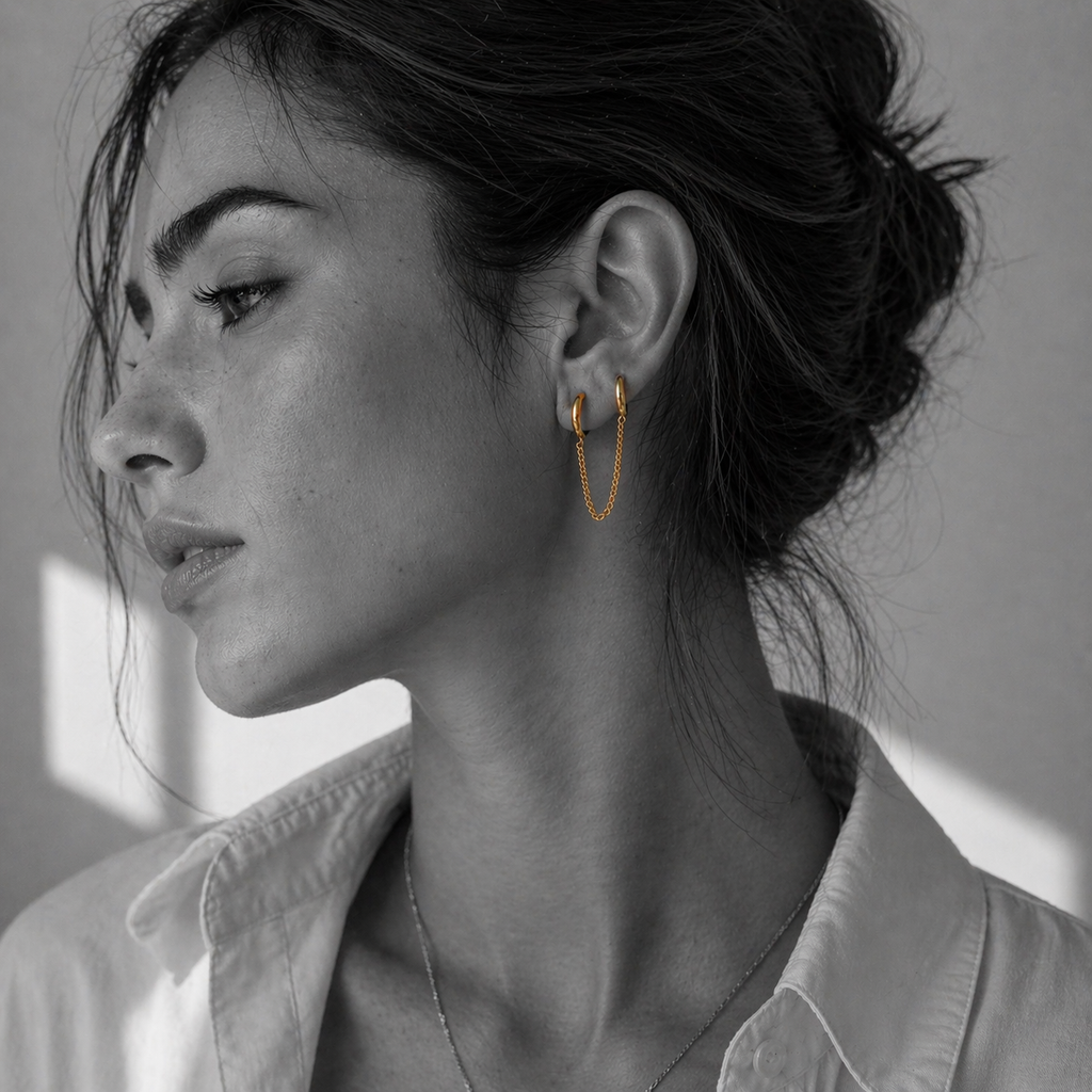 NAI earrings by Kaya & Olivia — worn on model, minimal chain hoops, elegant
