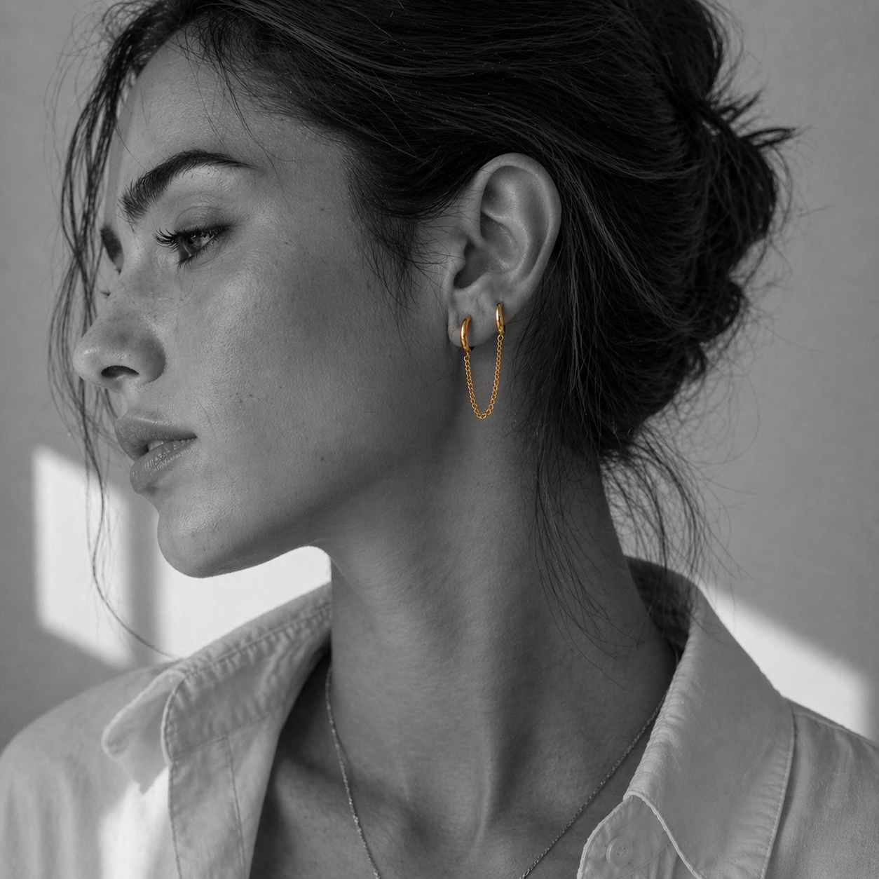 NAI earrings by Kaya & Olivia — worn on model, minimal chain hoops, elegant