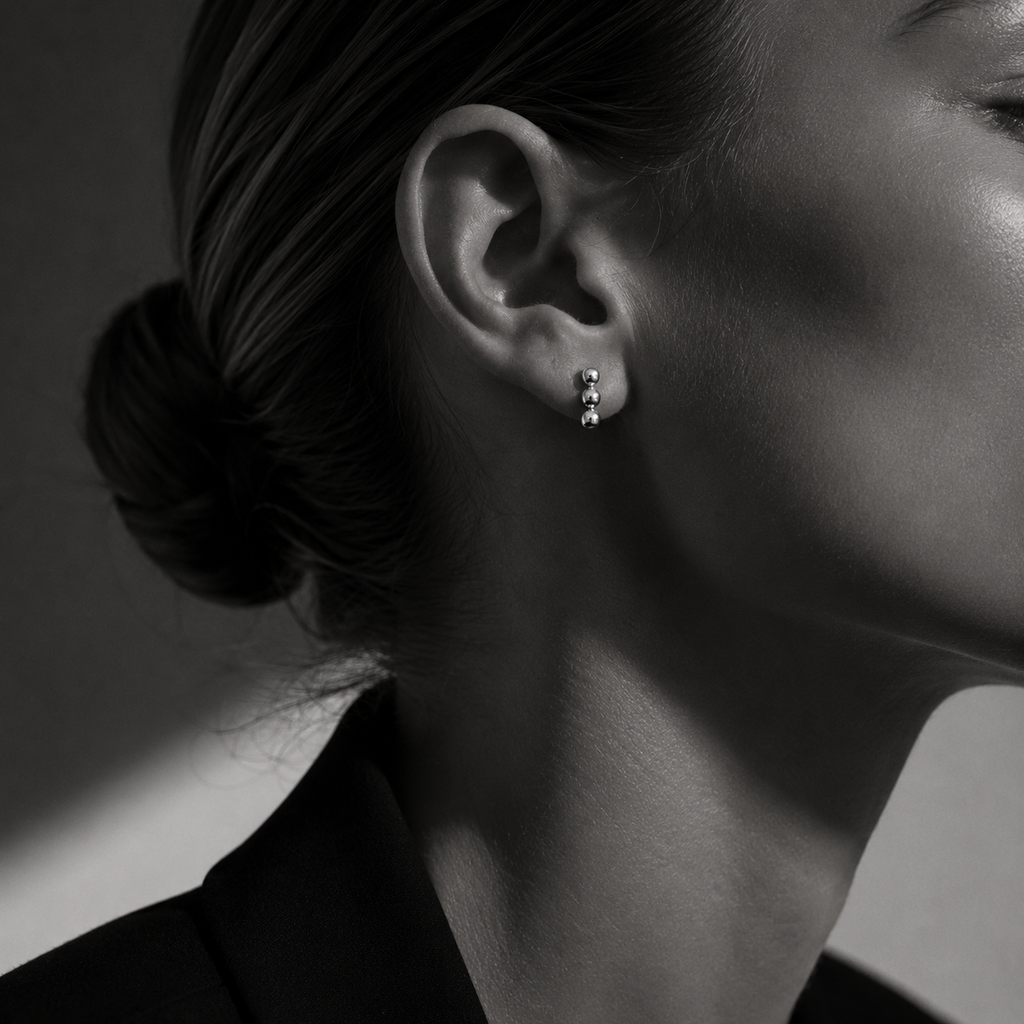 Tria Studs earrings by Kaya & Olivia — close-up on model, silver triple stud design