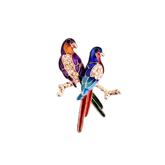 Pregadeira Love Birds em aço inoxidável com design de dois pássaros coloridos e cristais brilhantes, inspirada na natureza.
